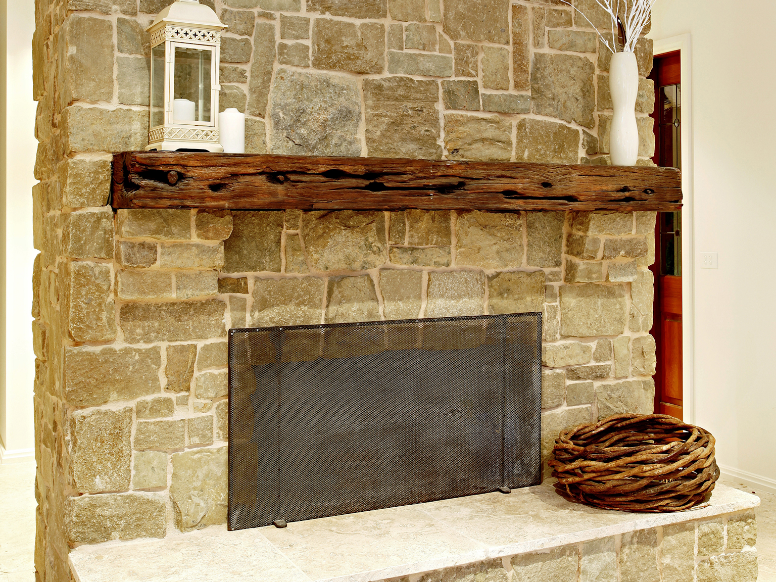 Clancy sandstone random ashlar walling used on internal fireplace with Capri travertine modular flooring and hearth piece