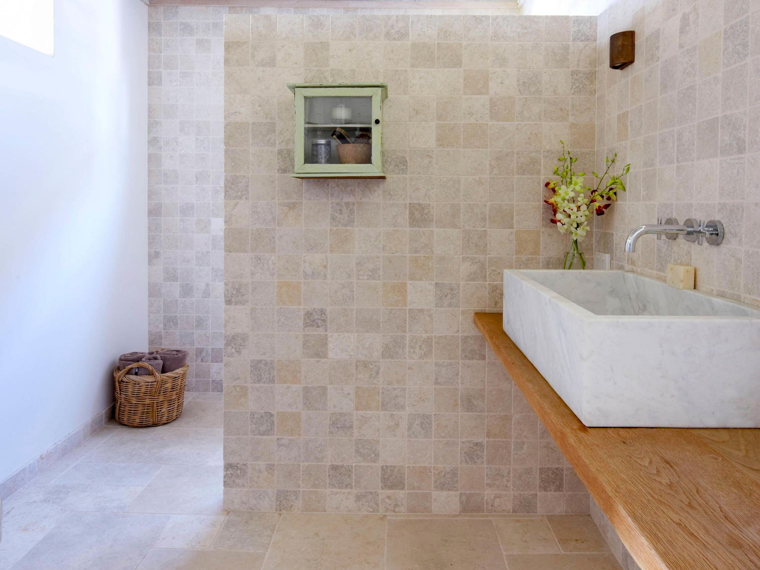 Bathroom timber bench with Jericho limestone floor and wall tiles 